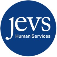 JEVS Human Services in white lettering inside a navy blue circle as their logo