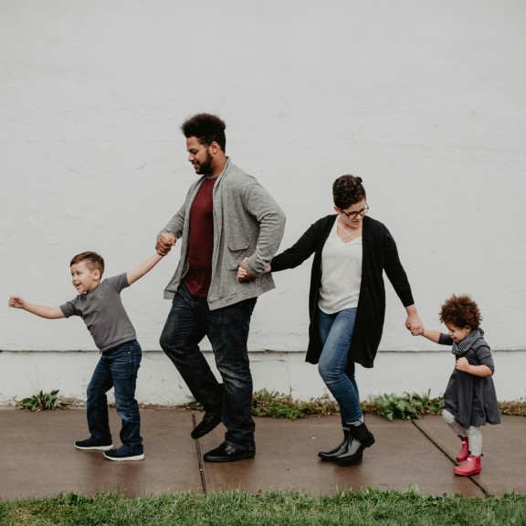 A family of four walking.