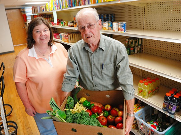 Migrated automatically. A man and woman working in a food pantry.