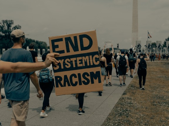 sign reading "end systemic racism"