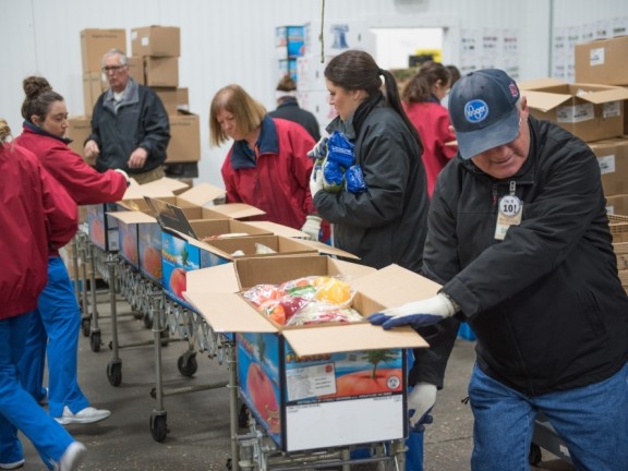 people packing up food boxes for donation