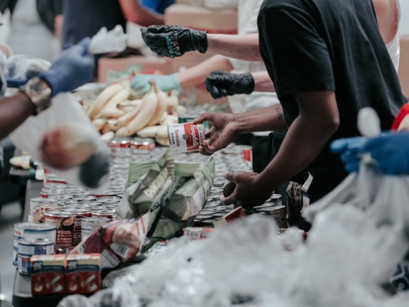 people packaging goods in pantry line