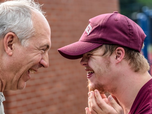 grandfather and grandson with down syndrome smiling