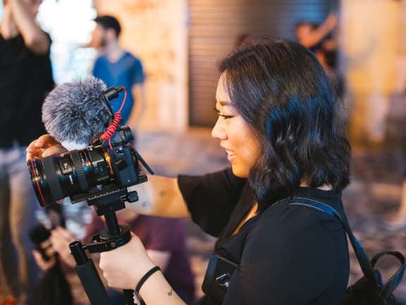 asian woman holding camera