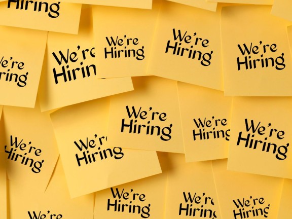 Yellow sticky notes with the text "We're Hiring"