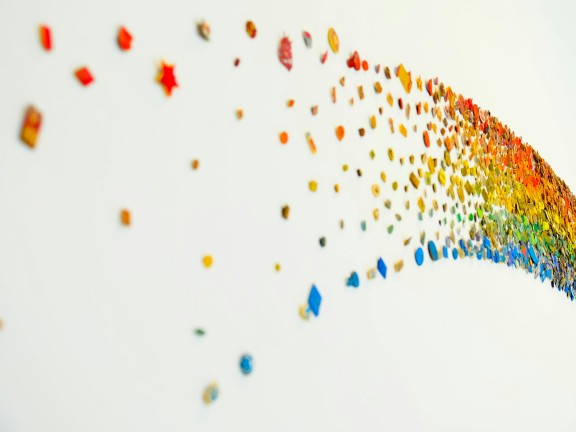 A colorful rainbow art installation on a wall.