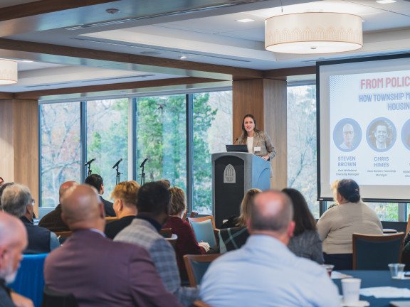 A woman talking to a group of people.