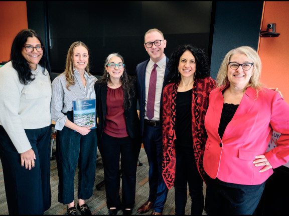 Six people smiling and looking at the camera. 