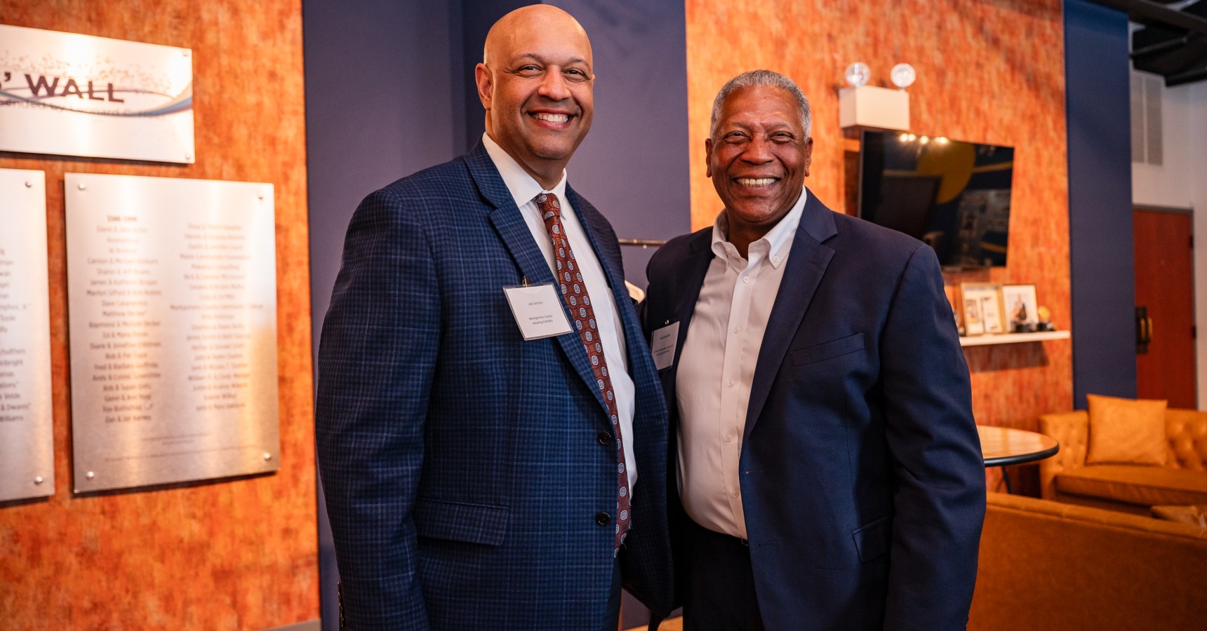 Two men smiling.