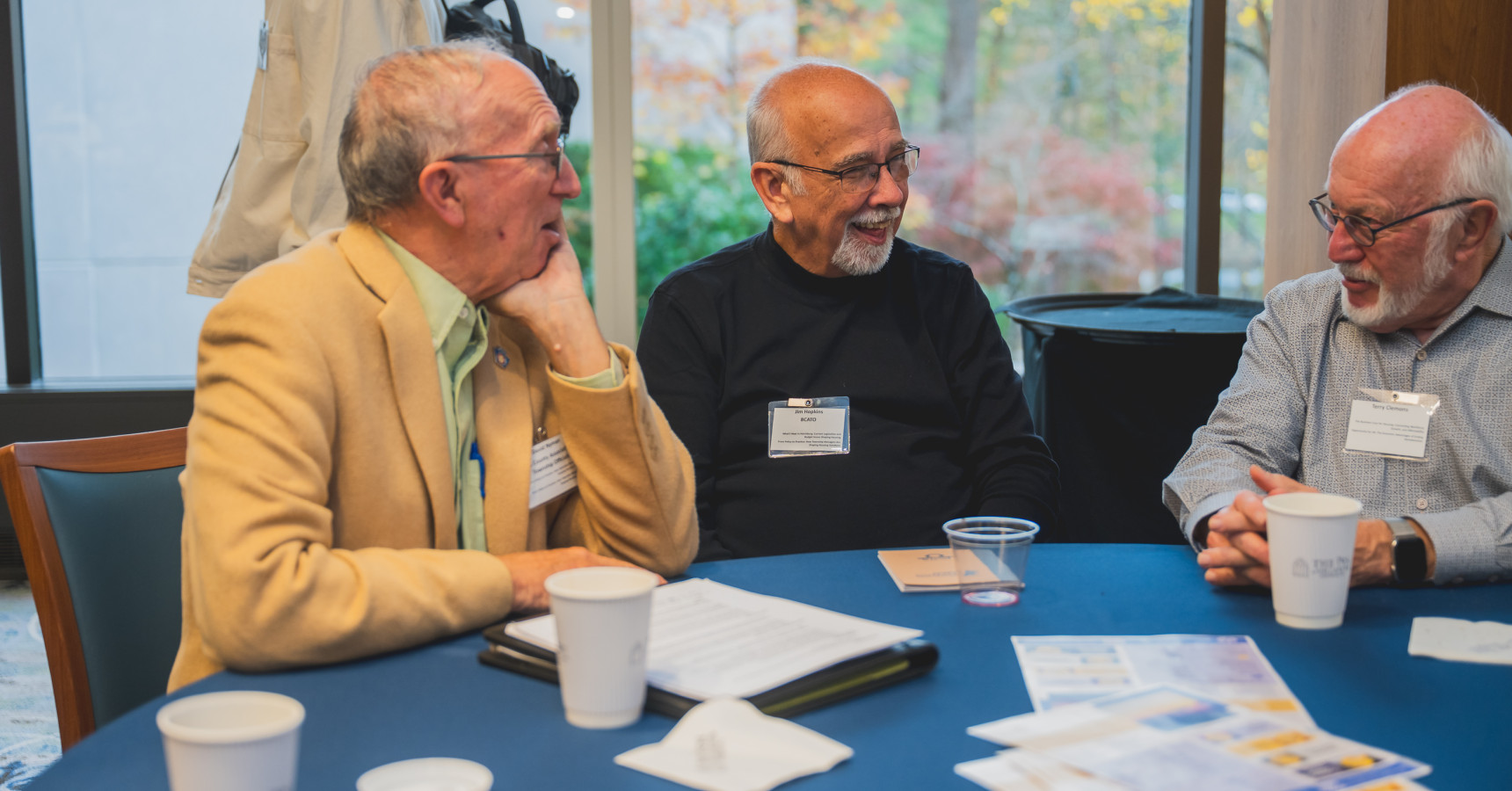 men at a table talking