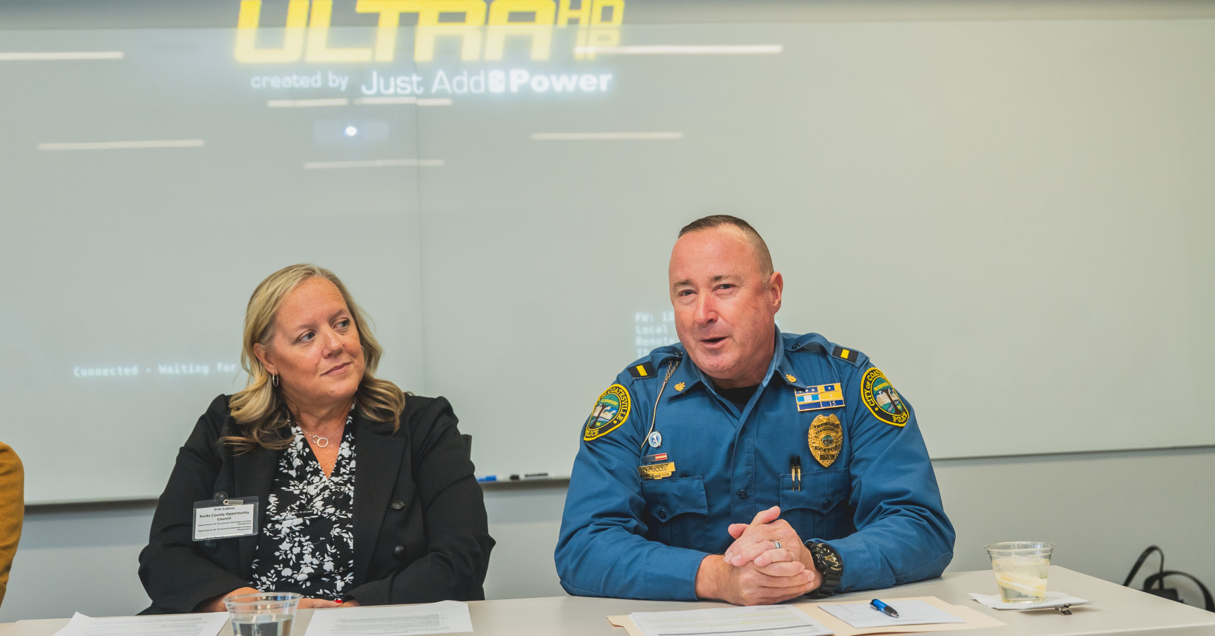 police officer and woman at a table