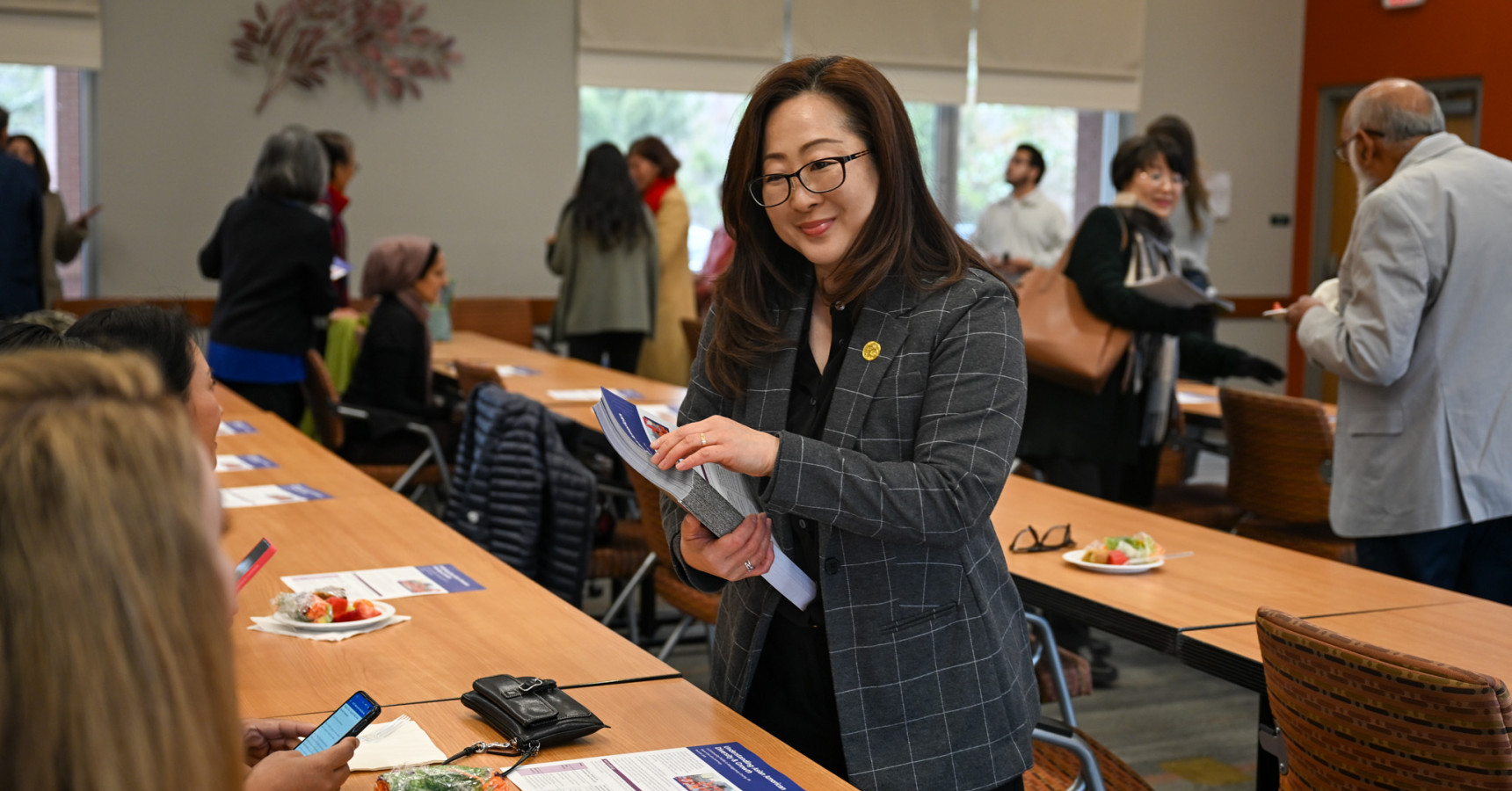 woman handing out papers