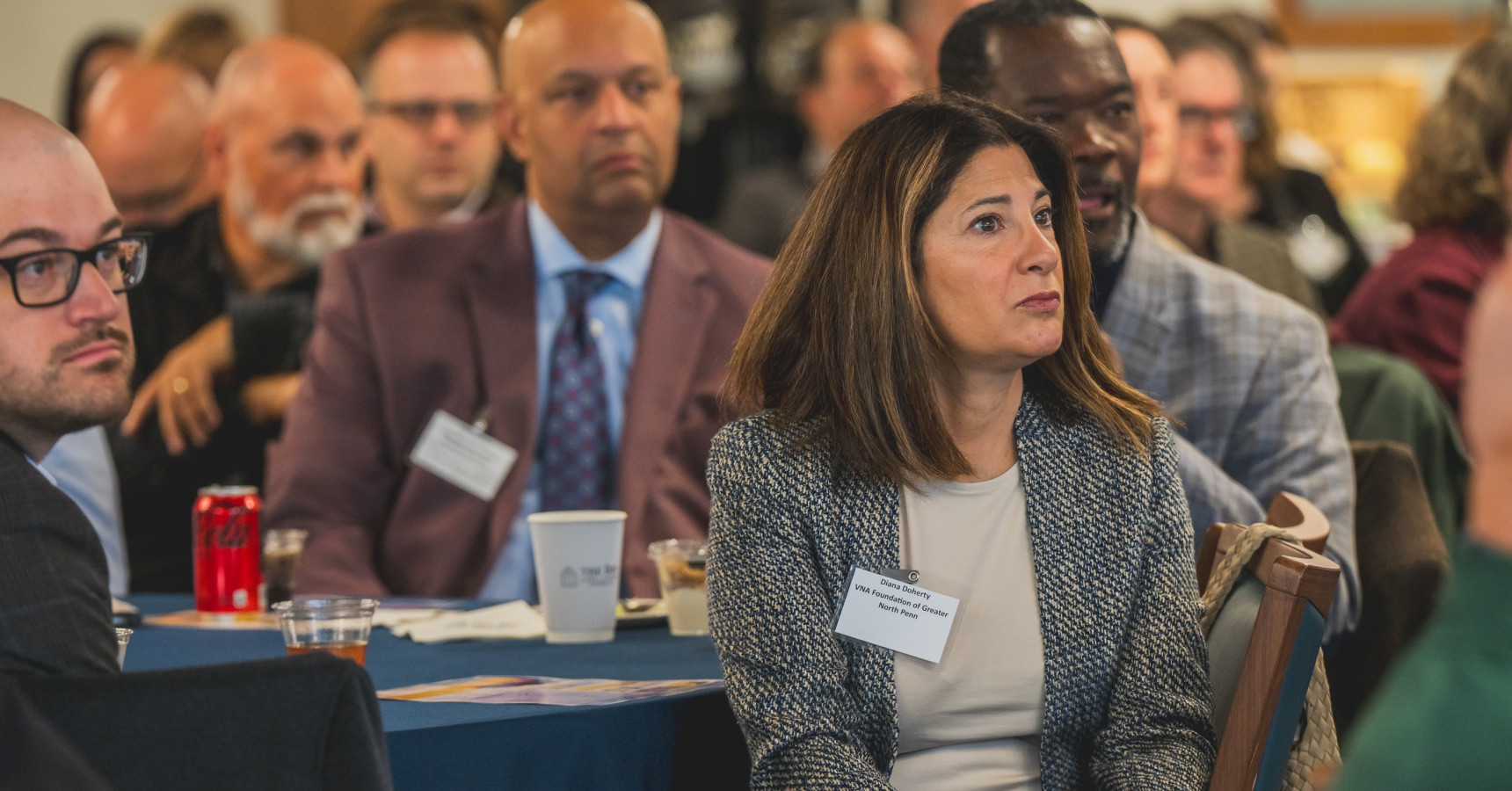 A woman listening to the speaker speak.