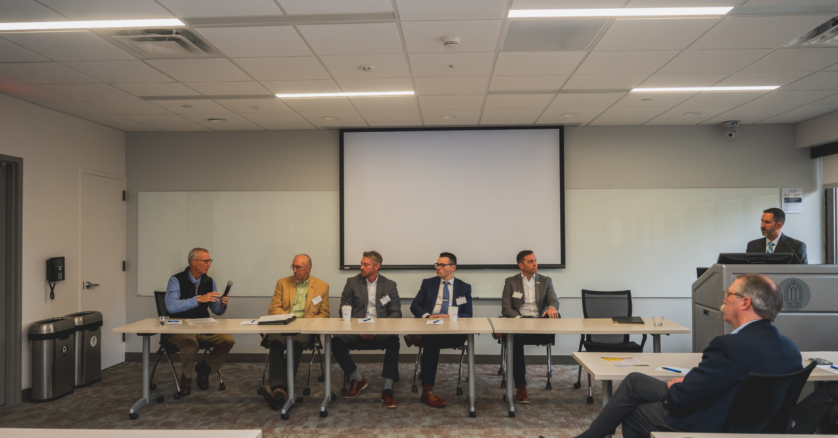 A panel of people speaking.