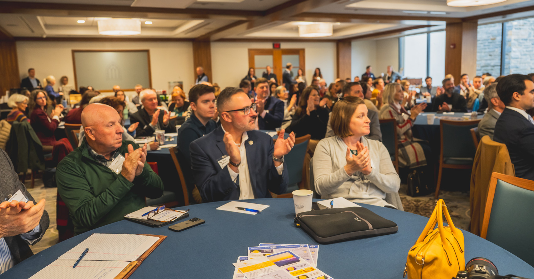 A group of people clapping.