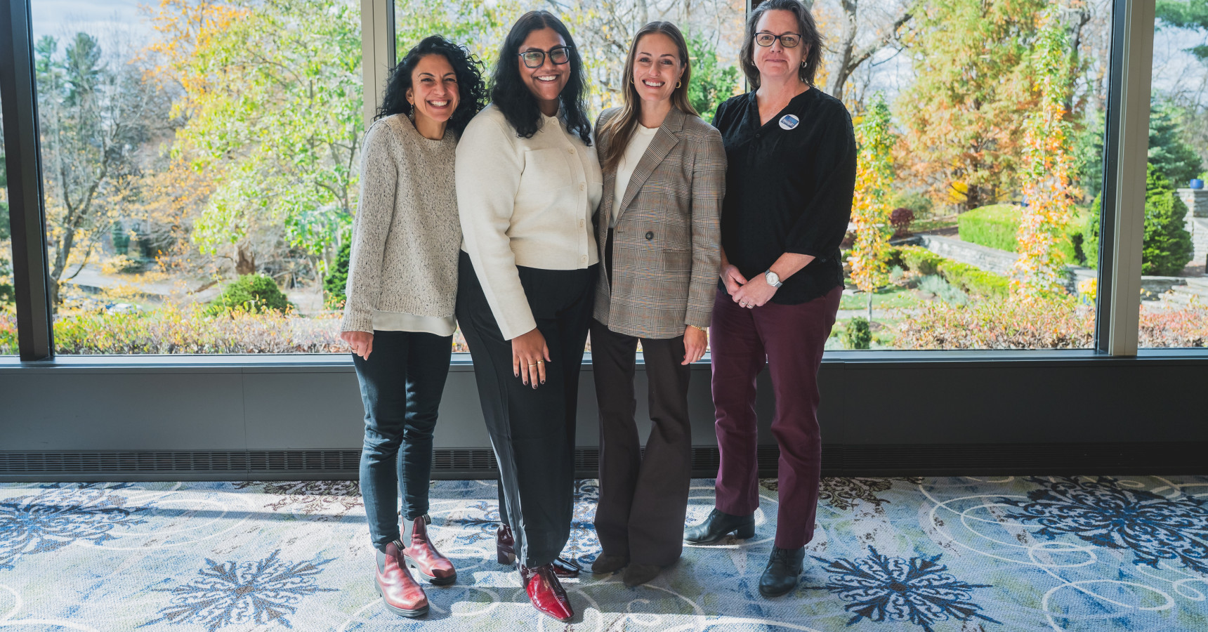 Four smiling ladies posing for a photo together.