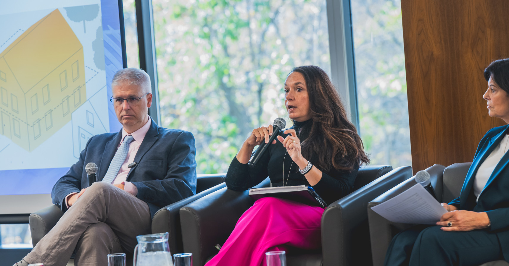 A woman speaking into a mic.
