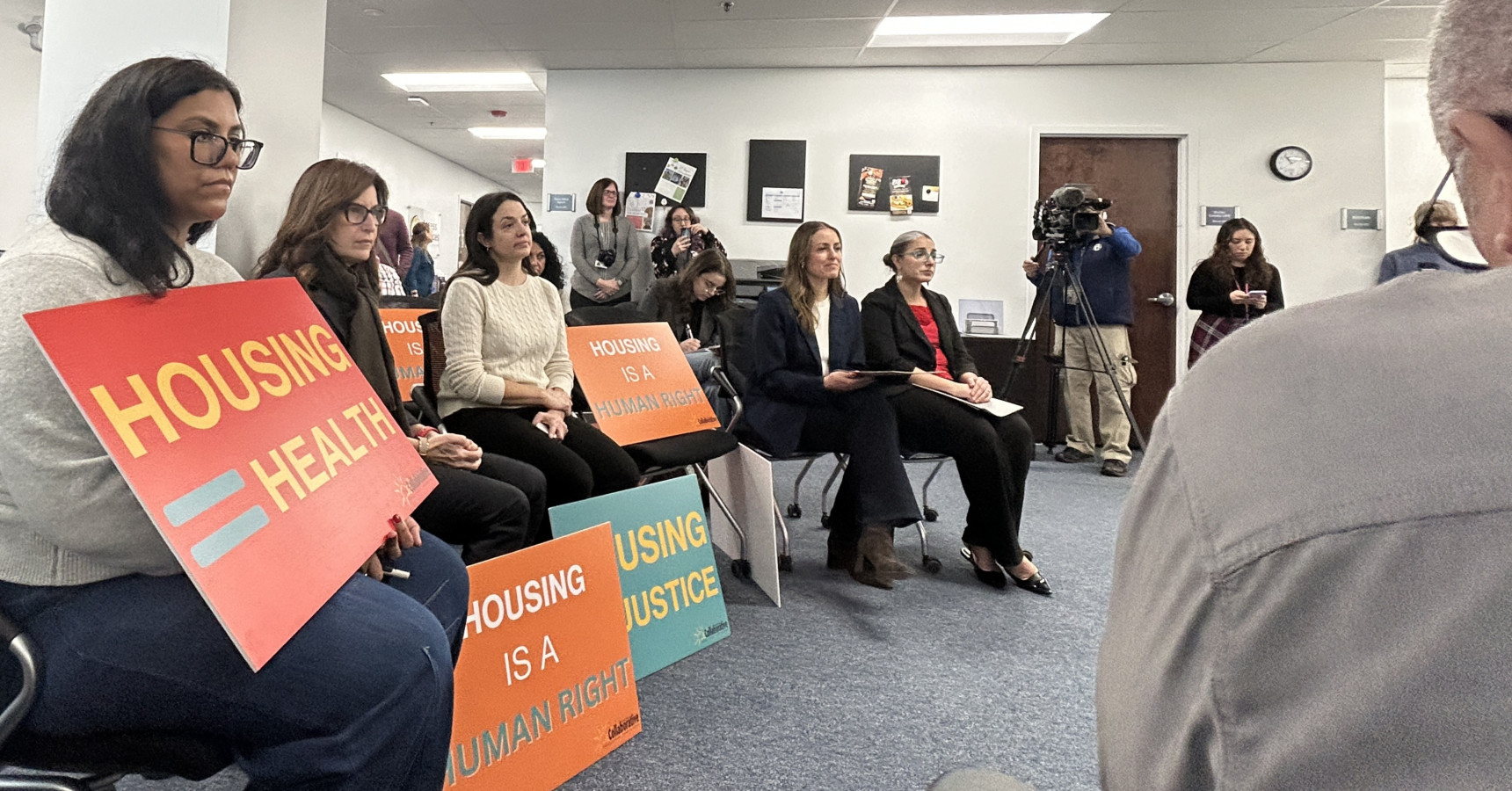 people in a room with signs