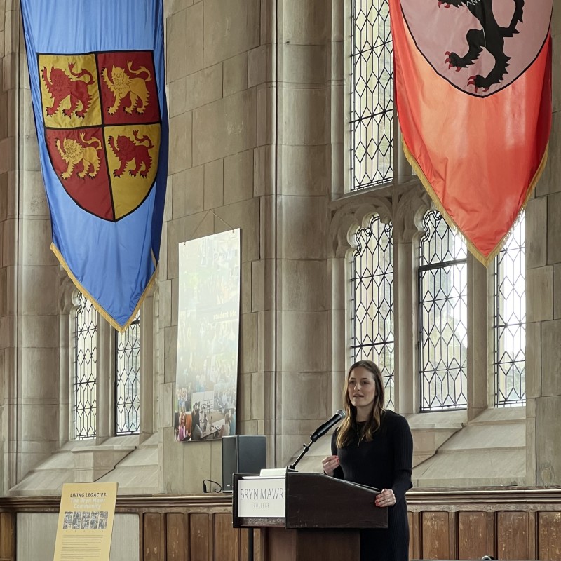 A picture of HealthSpark's President and CEO, Emma Hertz standing at a podium, giving her opening remarks.