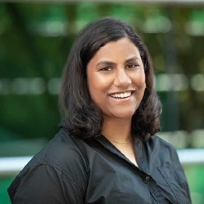 A picture of a smiling woman wearing a black shirt.