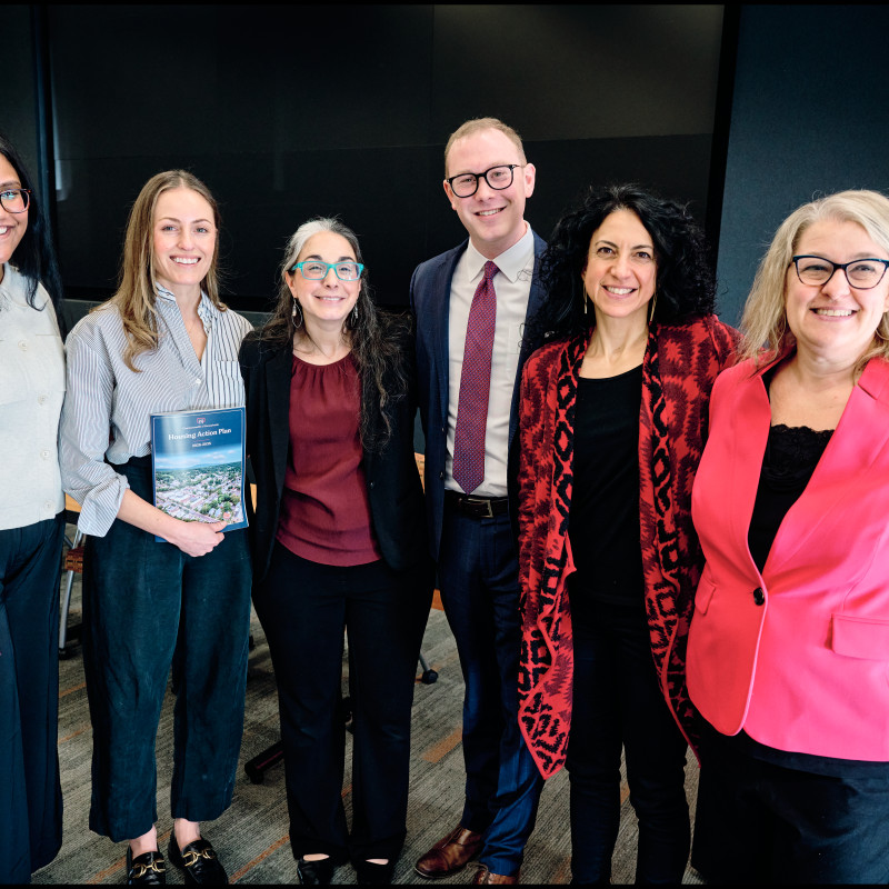 Six people smiling and looking at the camera. 