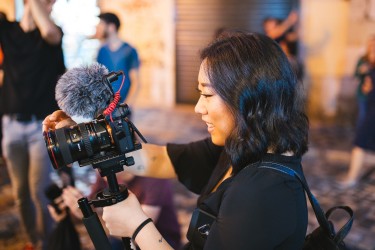 asian woman holding camera