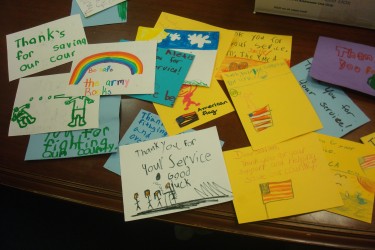 Handmade cards by kids on a table.