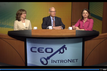 Two people being interviewed by a third person; all three are seated in a row.