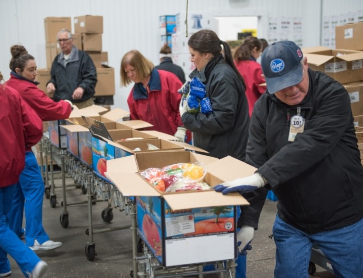 people packing up food boxes for donation