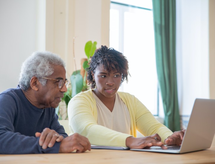 young woman and older adult using a computer