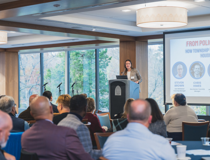 A woman talking to a group of people.